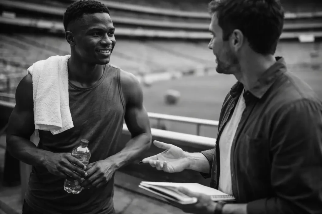 Professional athlete meeting with brand representative inside a stadium