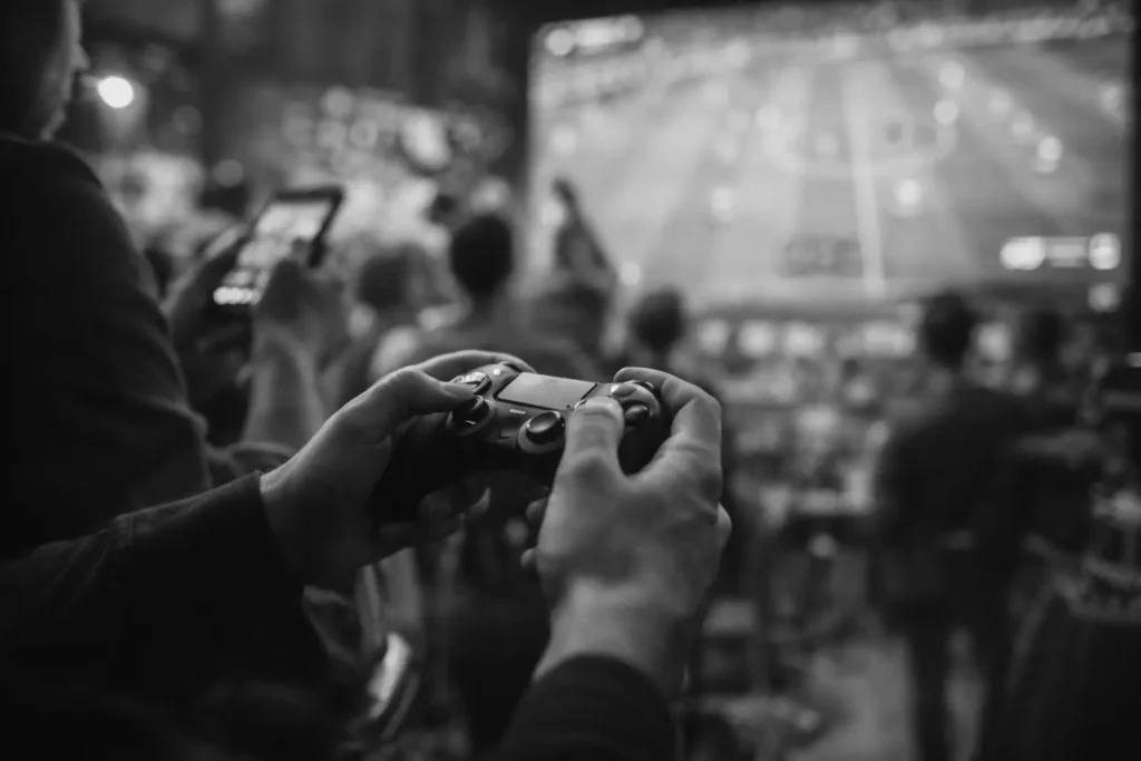 Fan engaging with an interactive digital sports experience using a gaming controller